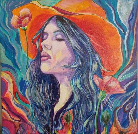 Woman in orange hat around flowers in bright colors